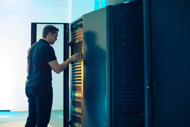 Young IT Technician Mainteining Supercomputer